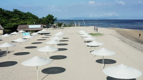 Rows of umbrellas in Sanur beach in Bali Indonesia Stock Footage 130362174