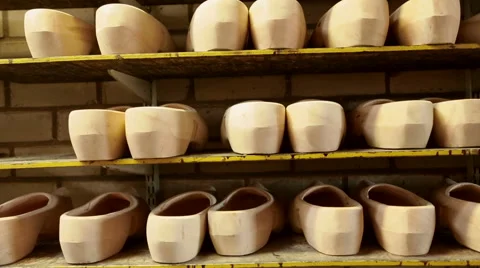 Rows of unfinished clogs on a shelf Video stock 46993933