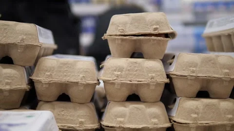 Rows upon rows of egg cartons are neatly stacked and aligned, creating a Video stock 318282988