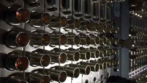 Rows of video SDI inputs and outputs in the back of a patch panel. Stock Footage 99596854