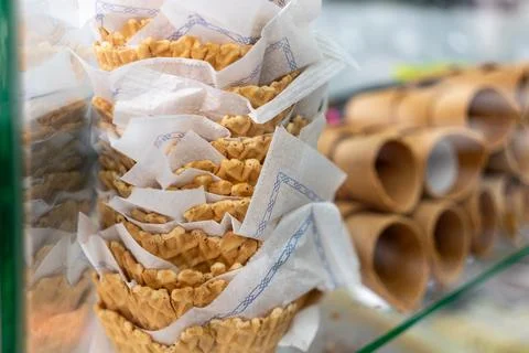 Rows of waffle cones prepared for ice cream service in dessert shop 库存照片