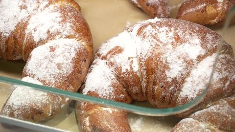 Rows of Warm Freshly Baked Bread Rolls on Display in Bakery Stand at Local Stock Photos