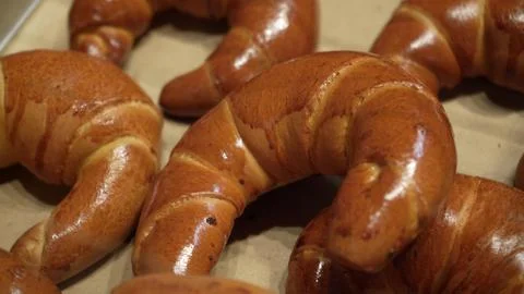 Rows of Warm Freshly Baked Bread Rolls on Display in Bakery Stand at Local Stock Photos