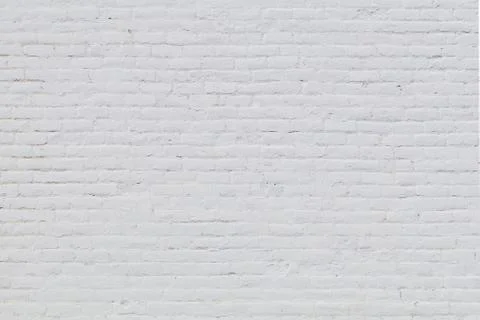 Rows of white bricks form a painted white brick wall Stock Photos