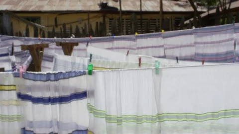 Rows of white cloth drying on laundry ropes on a sunny day Stock Footage 107018624
