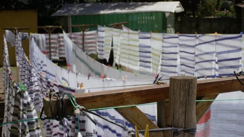 Rows of white cloth drying on laundry ropes on a sunny day Stock Footage 107019780