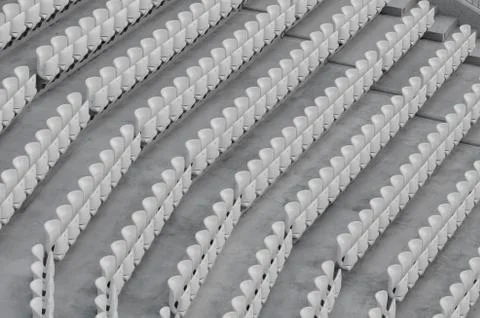 Rows of white empty plastic seats in a stadium Stock Photos