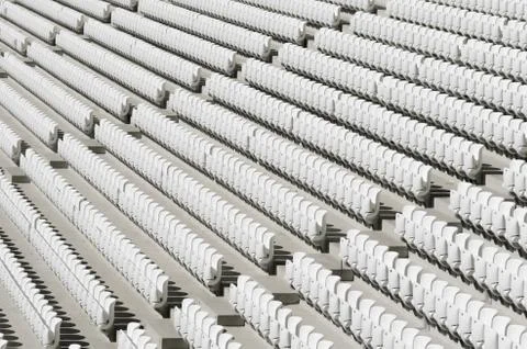 Rows of white empty plastic seats in a stadium Stock Photos