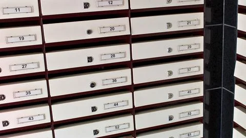 Rows of white storage boxes labeled and stacked Stock Photos