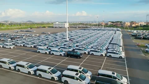 Rows of white vehicles in an outdoor storage lot in Guangzhou China Stock-Footage 345957481