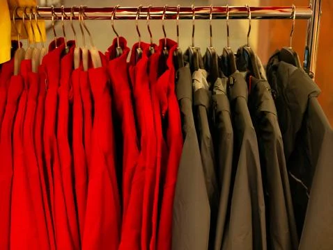 Rows of winter jackets and coats hanging on display rack Stock Photos