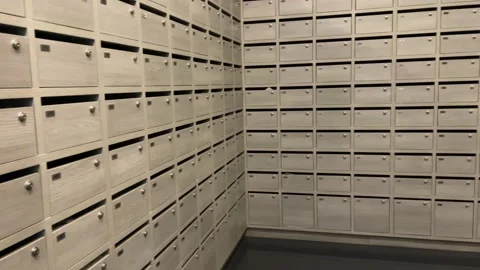 Rows of wooden mailboxes view inside mail room inside condominium. Видео 230095728