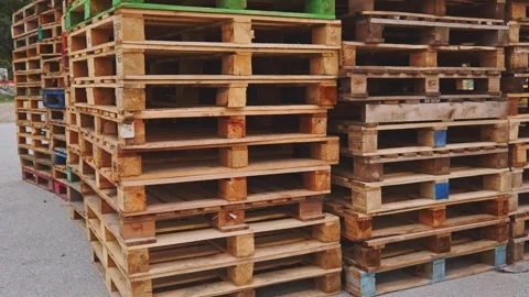 Rows of wooden stacked freight pallets in goods warehouse transport yard Vídeo Stock 290309104