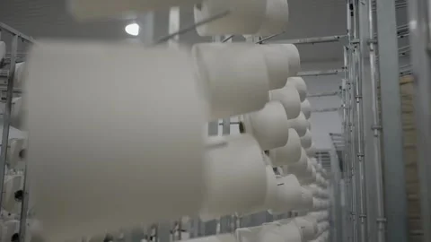 Rows of yarn spools on racks inside textile factory Stock Footage 327442263
