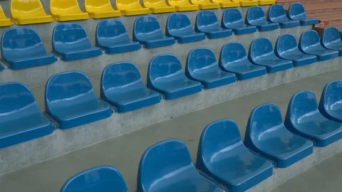 Rows of yellow and blue stadium or concert hall seats. Amphitheater seats. Video stock 102301629