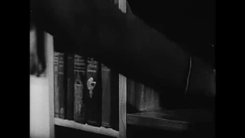 A Royal Air Force sergeant is interrogated by a German commandant in an office Stock Footage 115355366