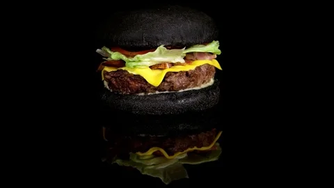 Royal Black Cheeseburger on black background with total reflection, loop Stock Footage 75253714