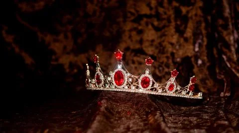 Royal Diadem, crown with ruby, red gemstones on velvet background Stockfoto's