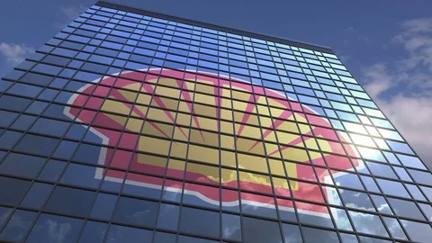 ROYAL DUTCH SHELL PLC logo on modern building reflecting sky and clouds Stock Footage 109419039