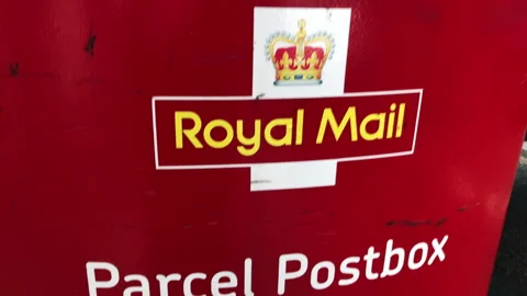 A Royal Mail parcel postbox with signage, slow pan up. Video stock 264051247
