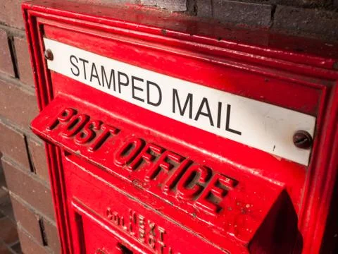 A Royal Mail red post office letterbox. Stamped Mail. Stock Photos