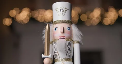Royal Nutcracker figurine dressed in a white costume, holding a sword, standing Stock Footage 287176829