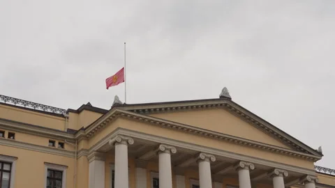Royal Standard Flag Flying at Half Mast over Oslo Royal Palace Facade Stock Footage 343951060