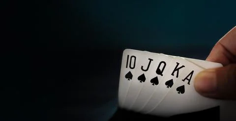 Royal State Flush Playing Card. Player Opening a Poker Card. Closeup and Da.. Stock Photos