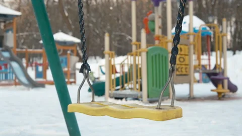 Rozen playground. Old swing on chain rope playground winter gloomy day Stock Footage 265674823