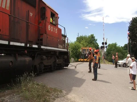 RR track removal - engine backs up pulling rails Stock Footage 74176359