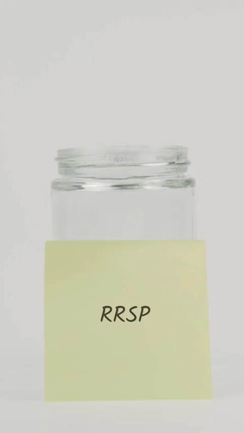 RRSP text or word on yellow sticky note attached to glass jar with hand Stock Footage 311783208