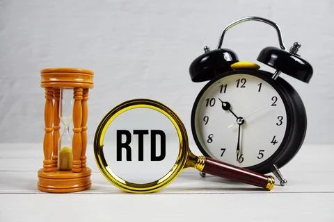 RTD abbreviation of Real Time Data text with alarm clock on wooden background Stock Photos