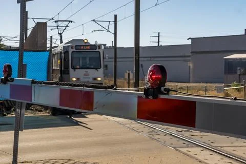 RTD Light Rail Train Behind Lowered Railroad Crossing Gate Stock Photos