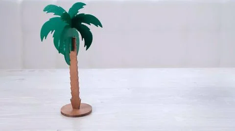 Rtificial palm tree and rainbow soap bubbles on a white wooden table. Relaxation Stock Photos