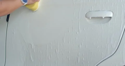 Rub the car with a yellow sponge.It's easier to wash your car with foam. Stock Footage 310330891