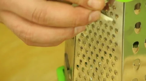 Rub cheddar cheese on a grater Stock Footage 62418332