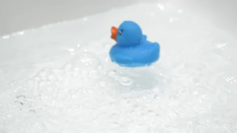 Rubber bath duck floating on water 4K Stock Footage 98082830