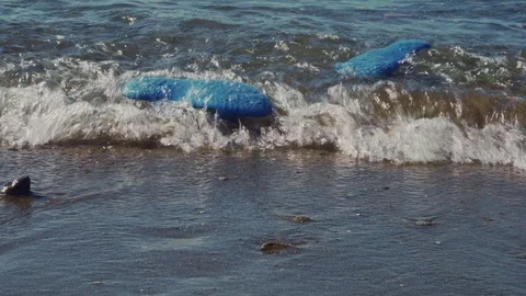 Rubber beach slippers in ocean waves. Stock Footage 124757155