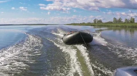 Rubber boat in a towrope on a river Stock Footage 56205902
