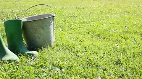 Rubber boots on grass Stock Footage