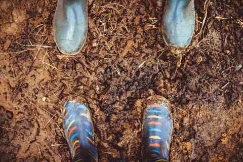 Rubber boots in mud Stock Photos