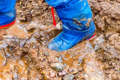 Rubber boots in the mud Stock Photos