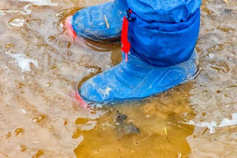 With rubber boots in the puddle Stock Photos