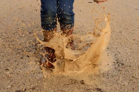 Rubber Boots Splashing Puddle Stock Photos