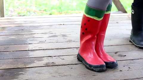 Rubber boots with watermelon pattern on women's legs Stock Footage 93640130