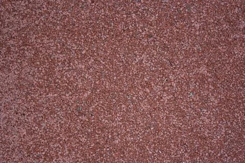 Rubber coating pattern of sports fields and tracks. Fine burgundy-coloured Stock Photos