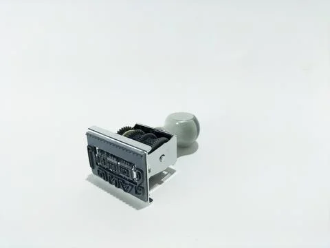 Rubber date stamp on blank white paper Stock Photos