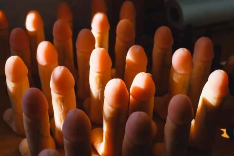 Rubber dildos stand upright on the table. Products for sex shop. Stock Photos