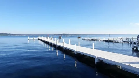 Rubber dinghy approaching a pier, Lake Geneva, Wisconsin, America Stock Footage 217470355