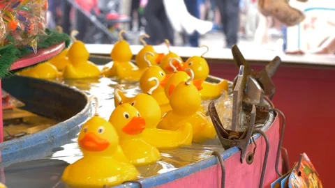 Rubber ducks going around a fun fair game Stock Footage